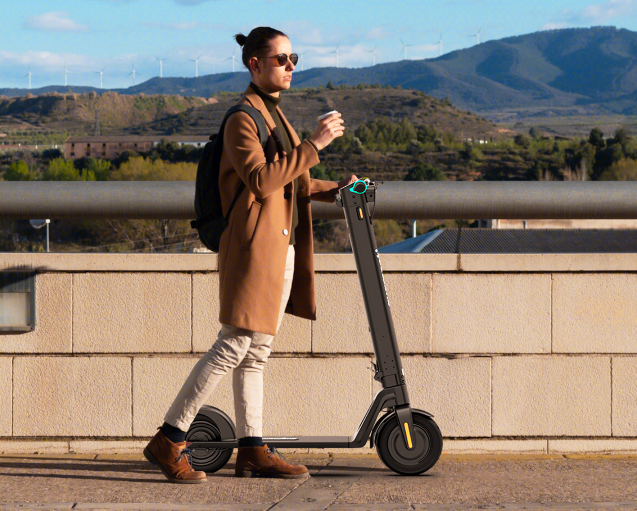 Commuter walking with a folding EU-spec electric scooter, the Smilescooter D01